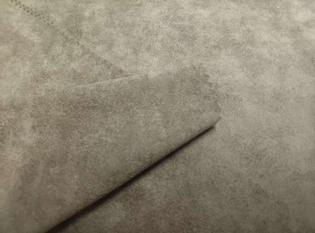 Warp knitted high gram weight four way stretch suede polyester fabric