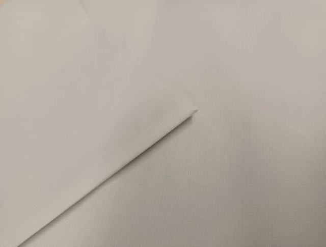 Recycled 200D nylon fabric double line ripstop.
