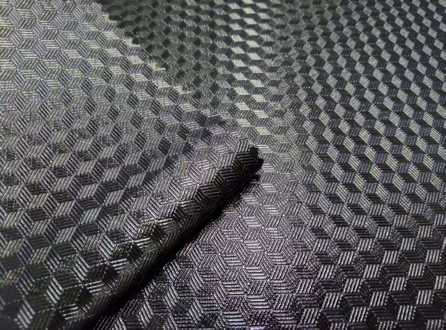 Semi transparent TPU is pasted on 600D fabric, with a 3D embossed pattern and a glossy finish